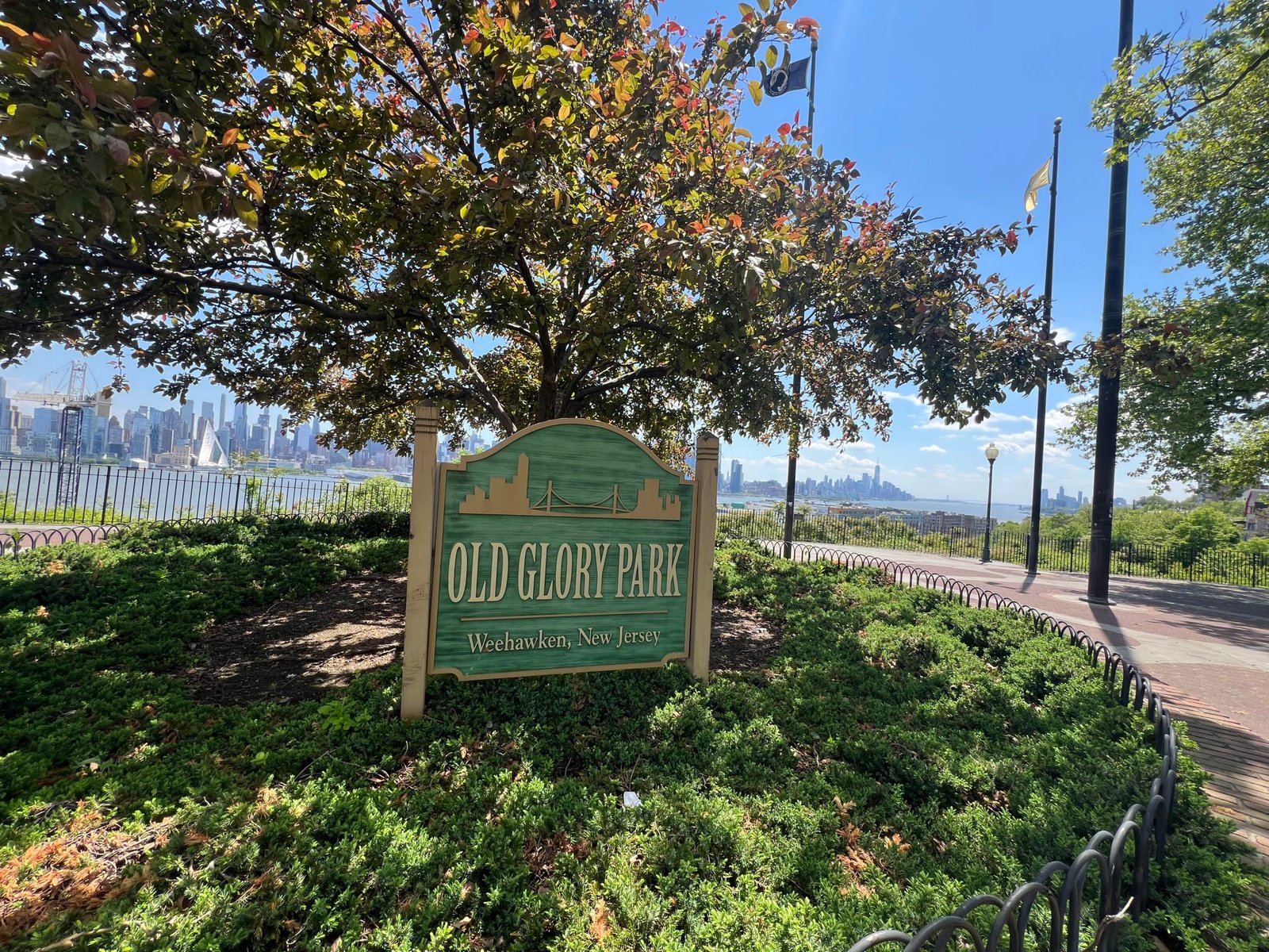 Old Glory Park sign with Manhattan skyline in background